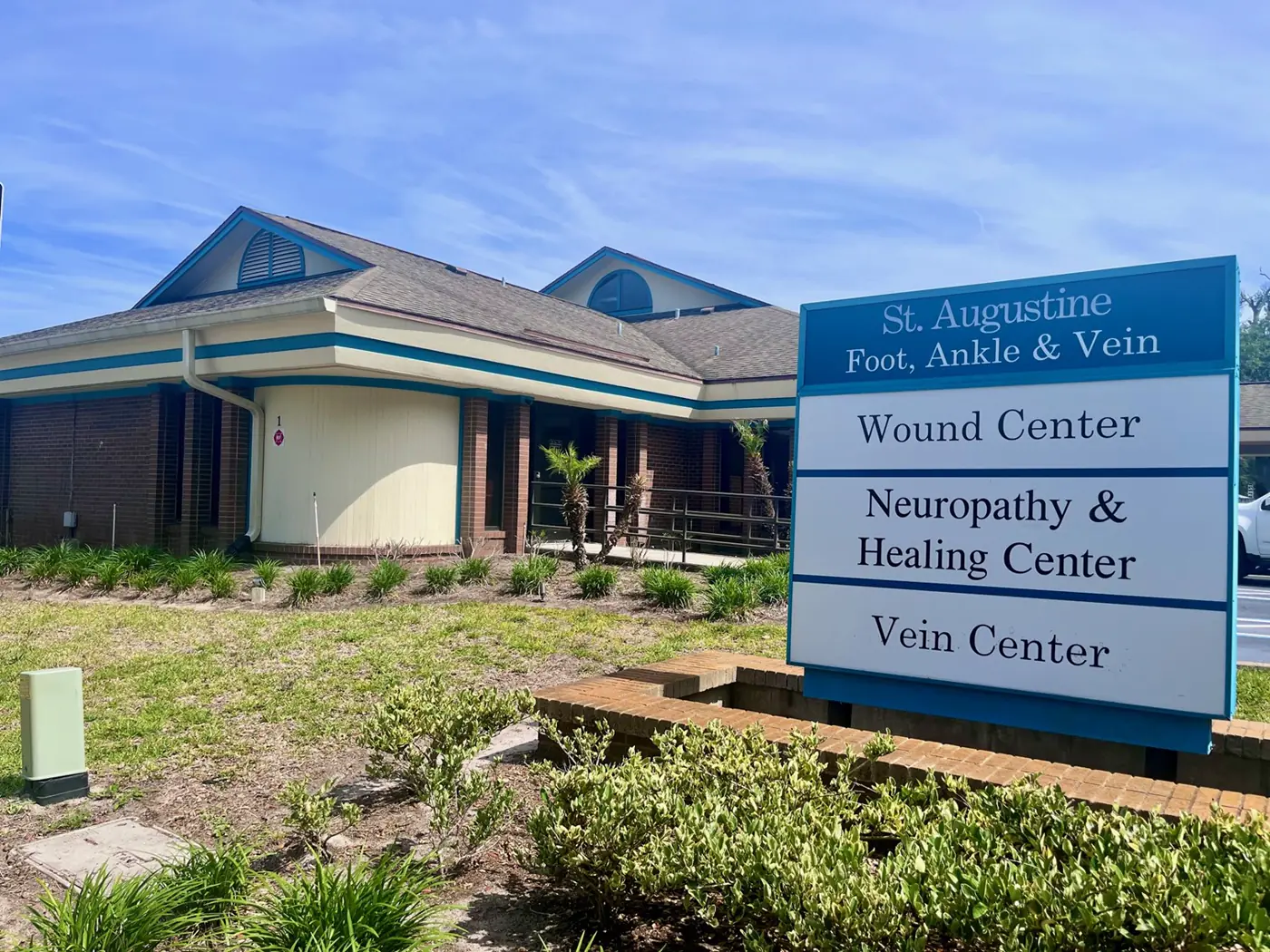 The center’s building, with a roadside sign reading St. Augustine Foot, Ankle & Vein above three lines: Wound Center, Neuropathy & Healing Center, and Vein Center