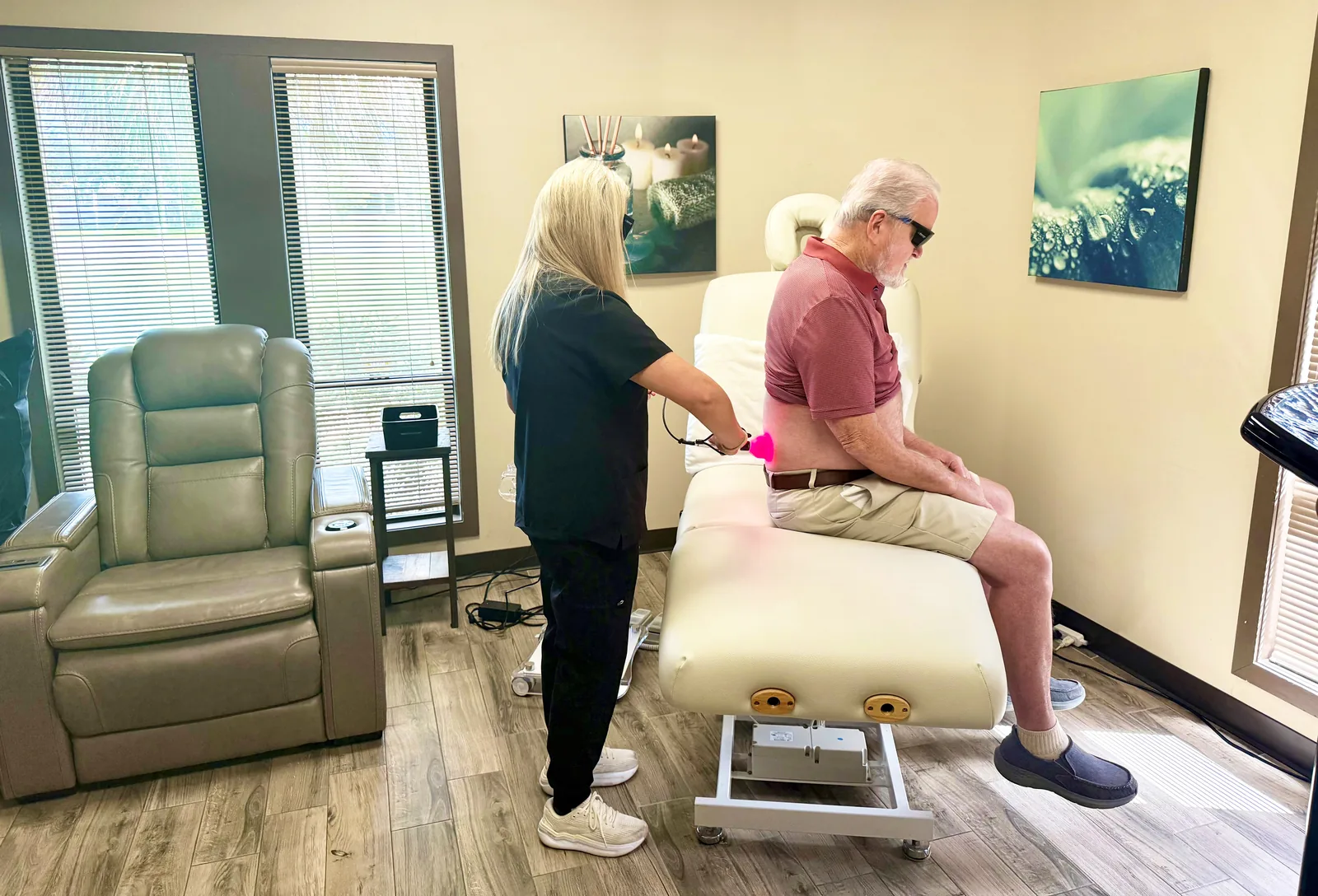 A clinician treating a patient’s lower back with the Class IV laser at the center