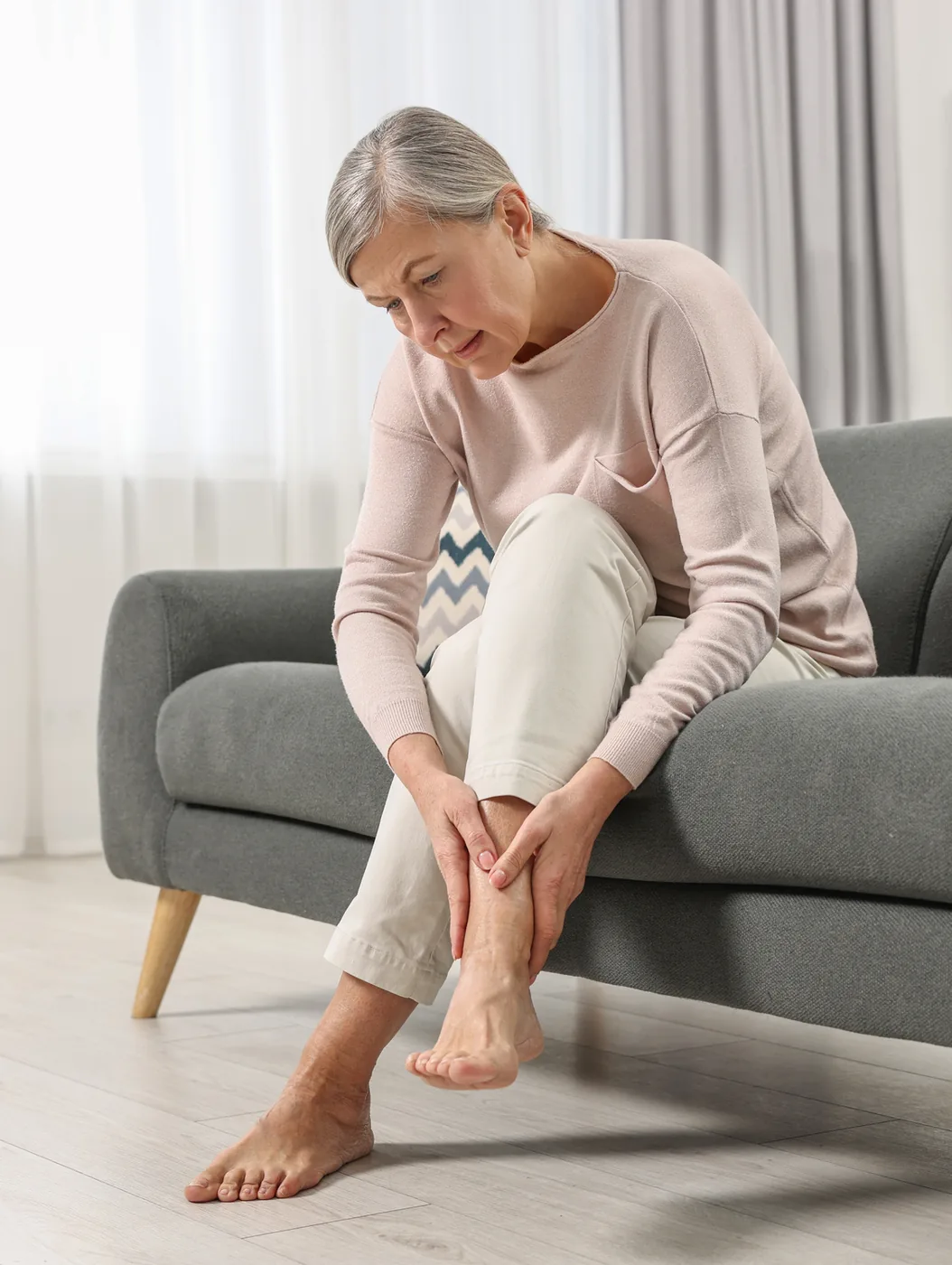 A person massaging a painful foot